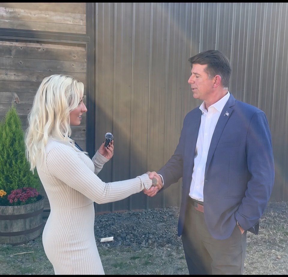 Right Side Rebel shaking hands with Treniss Evans